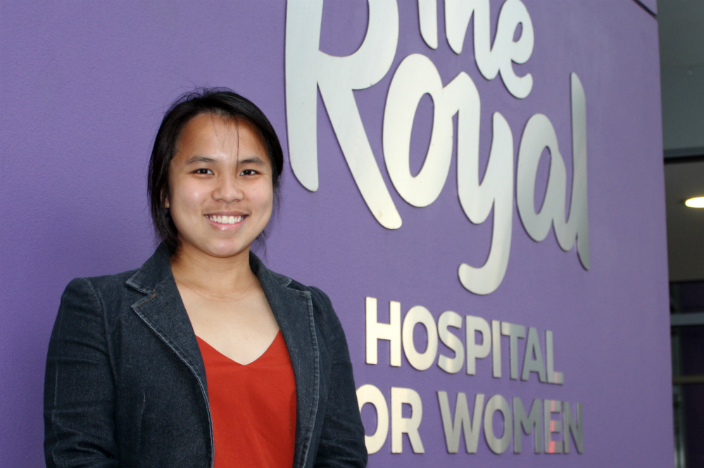 Amanda Khor standing in front of purple Royal Hospital signage 