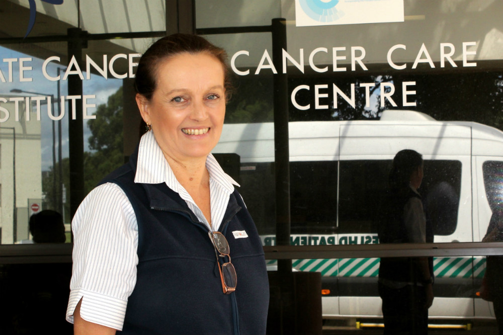 Patricia Morris standing in front of Cancer Centre entrance