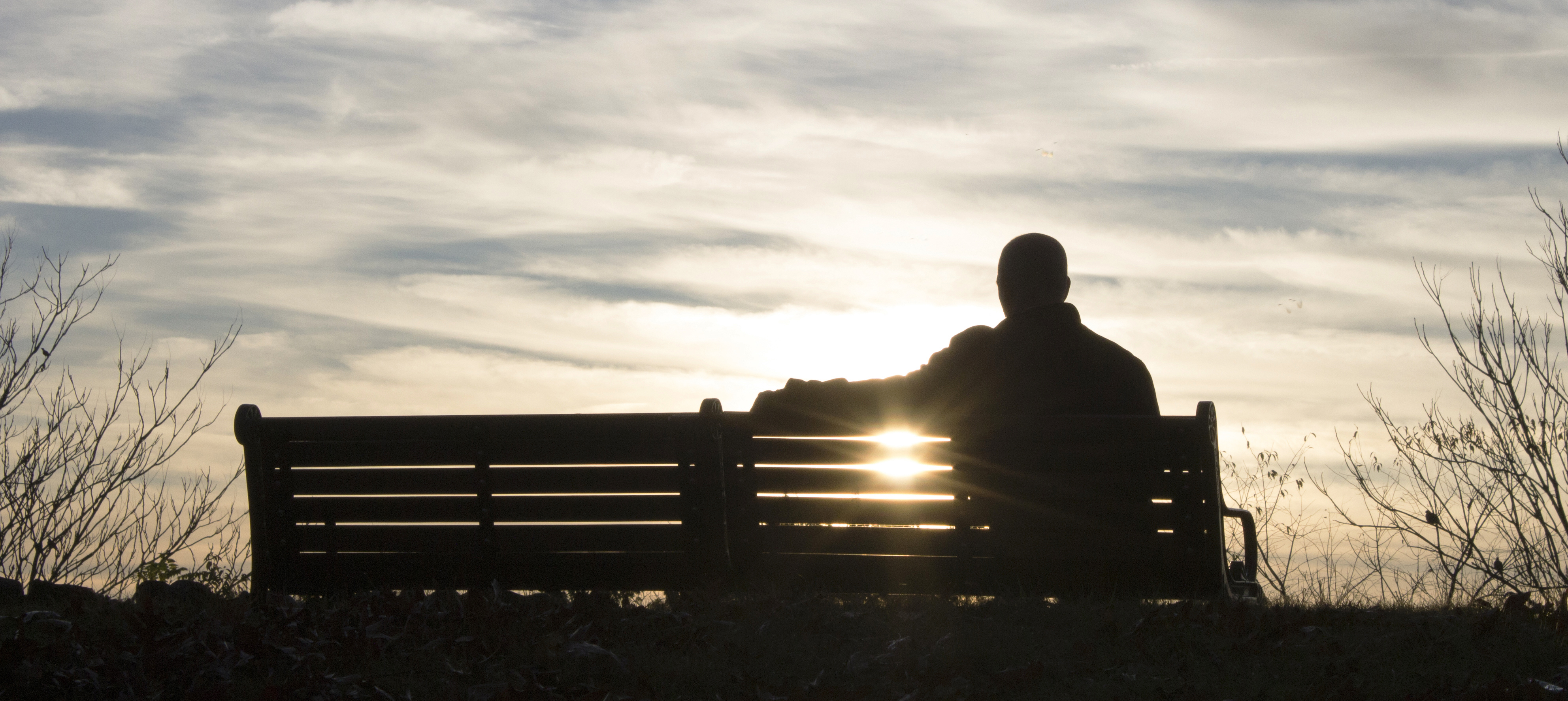 Sillouette of a man on a park bench