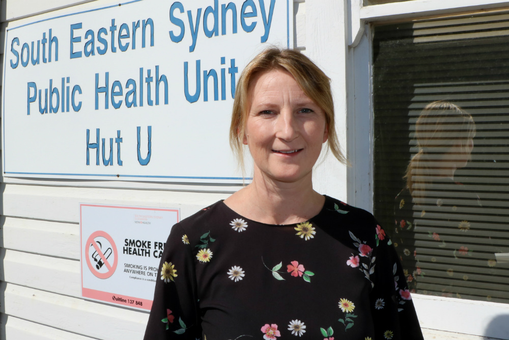 Lady in front of Public Health Unit sign
