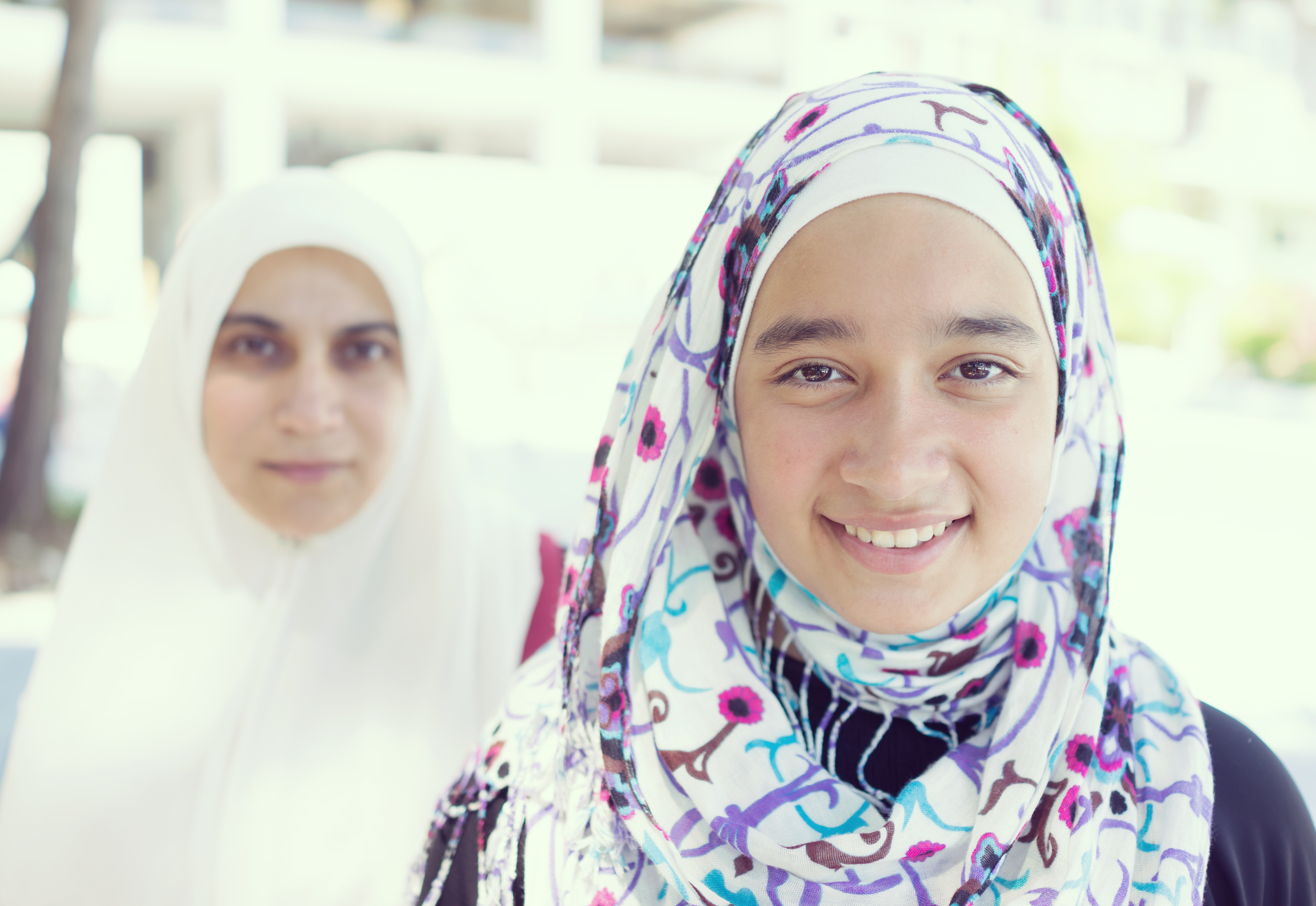 Two smiling young women wearing hijabs