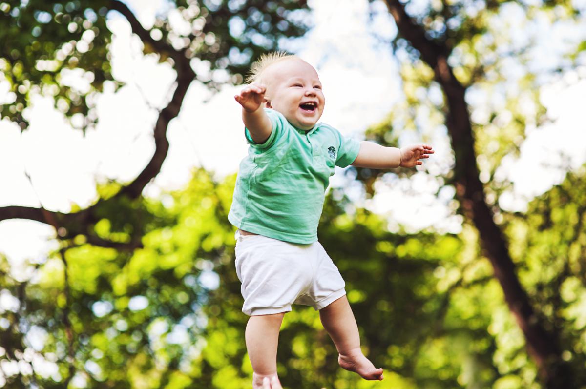 Baby thrown in the air laughing