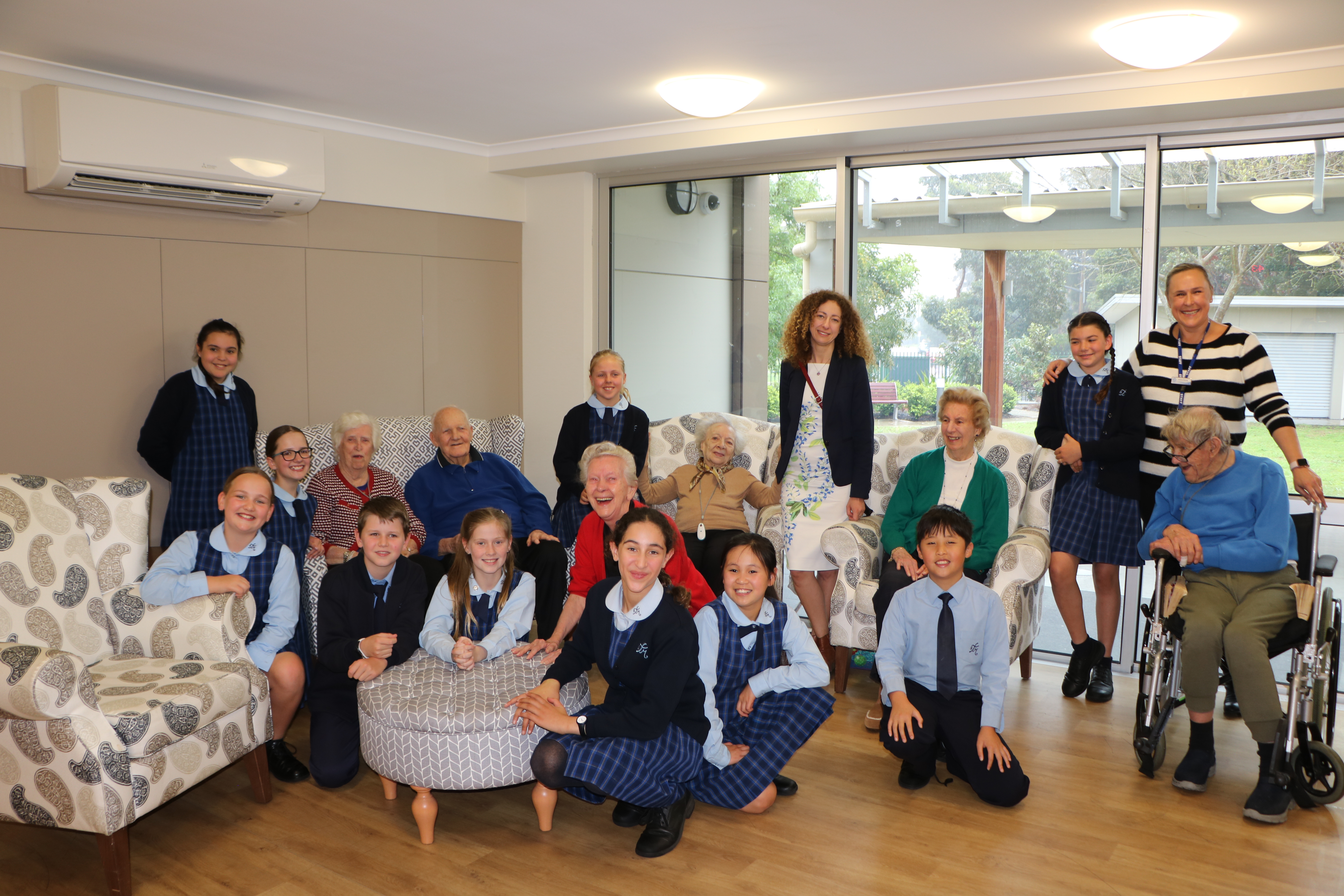 Group of school children with nursing home residents
