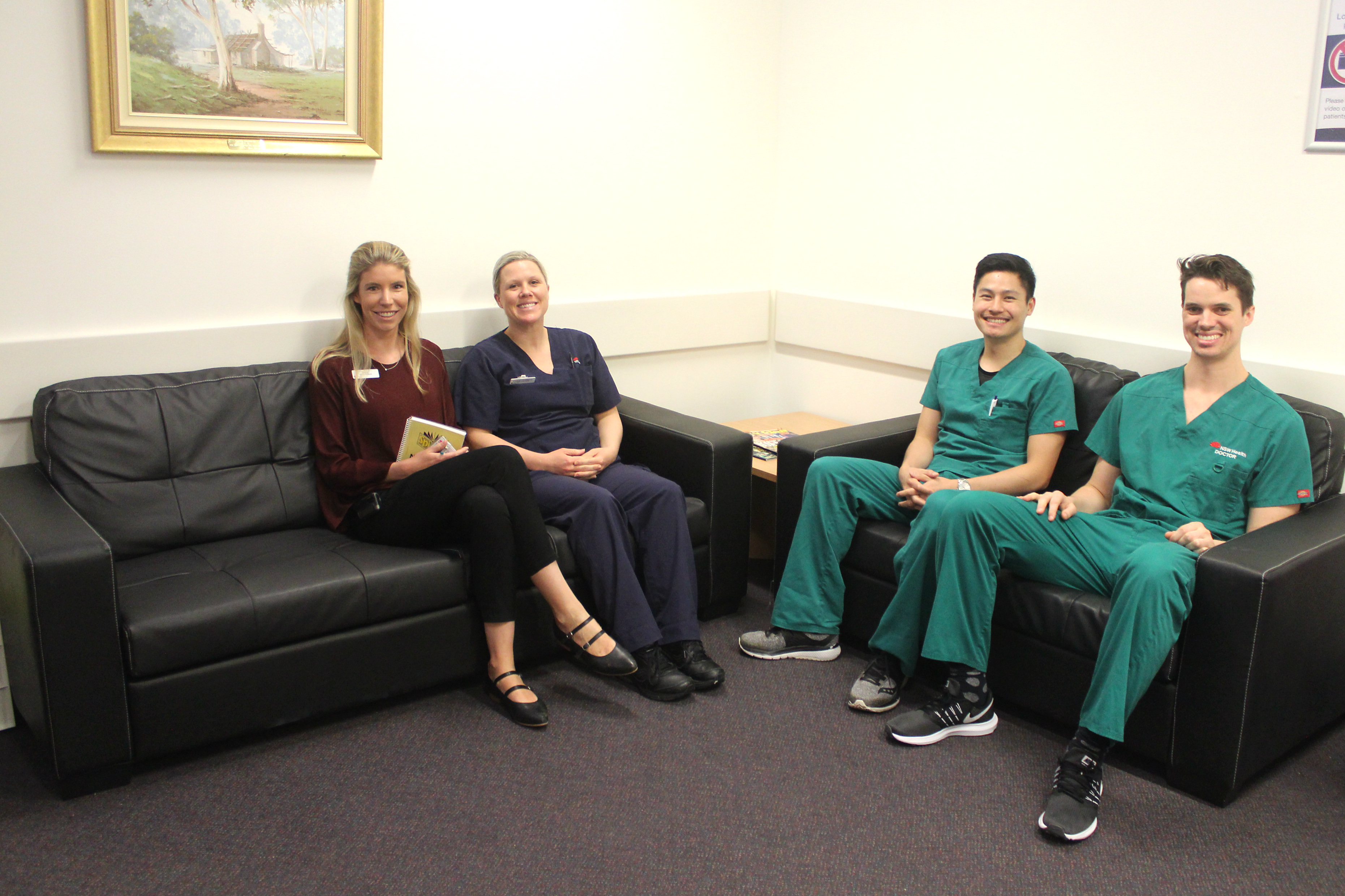 Nurses from the Intensive Care Unit sitting on the couches smiling 