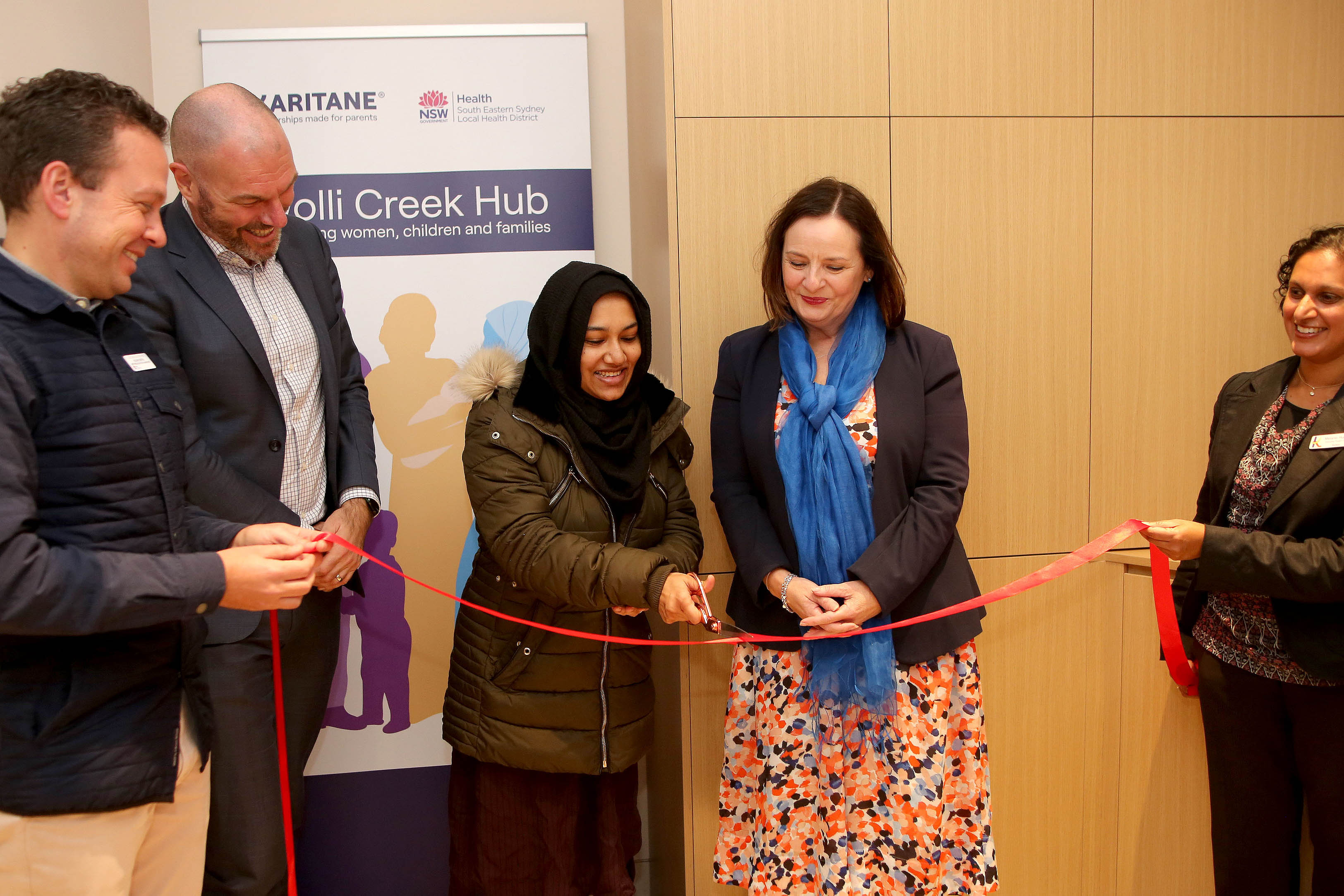 Five people cutting red ribbon at opening of Wolli Creek Health Care Hub